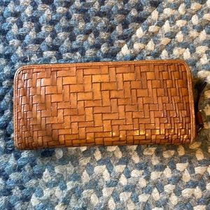 Cole Haan weaved leather zip wallet.